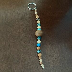 A glass and wooden bead keychain